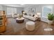Virtually staged living room featuring a comfortable sofa and armchairs, a coffee table, and a stylish rug at 1611 Copper Cir, Mebane, NC 27302