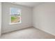 Carpeted bedroom with a window offering a view of greenery at 18 Virgo Dr, Angier, NC 27501