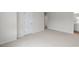 Spacious carpeted bedroom with an open door and natural light at 18 Virgo Dr, Angier, NC 27501