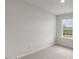 Well-lit bedroom featuring a window with a view and carpeted floors at 18 Virgo Dr, Angier, NC 27501