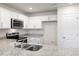 Modern kitchen with white cabinets, granite counters, and stainless steel appliances at 18 Virgo Dr, Angier, NC 27501