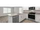 Kitchen with granite island, stainless steel appliances, and hardwood floors at 18 Virgo Dr, Angier, NC 27501