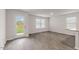 Living area with hardwood floors, windows and backyard access at 18 Virgo Dr, Angier, NC 27501