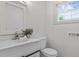 Inviting bathroom with modern fixtures, white vanity, and a window for natural light at 205 Spring St, Louisburg, NC 27549