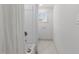 Clean, bright bathroom featuring a shower/tub combo and a window for natural light at 205 Spring St, Louisburg, NC 27549