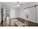 Bright bedroom features a sliding barn door to the bathroom and hardwood floors at 205 Spring St, Louisburg, NC 27549