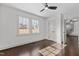 Bright bedroom features hardwood floors, a ceiling fan, and natural light streaming through the double windows at 205 Spring St, Louisburg, NC 27549