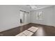 Bright bedroom features a sliding barn door closet, hardwood floors, and a modern ceiling fan at 205 Spring St, Louisburg, NC 27549