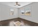 Sunlit bedroom features hardwood floors, neutral paint, and two windows for ample natural light at 205 Spring St, Louisburg, NC 27549
