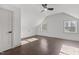 Bright, airy bonus room with wood floors, two windows, and a modern ceiling fan at 205 Spring St, Louisburg, NC 27549