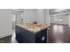 Kitchen island featuring a butcher block top and storage cabinets, perfect for meal prep and casual dining at 205 Spring St, Louisburg, NC 27549