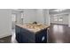 Dark kitchen island with wood countertop at 205 Spring St, Louisburg, NC 27549