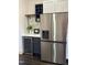 Kitchen boasts stainless steel refrigerator, wine cooler, and beverage center for convenient entertaining at 205 Spring St, Louisburg, NC 27549
