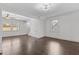 Inviting living room with hardwood floors, ceiling fan, and natural light through bright windows at 205 Spring St, Louisburg, NC 27549