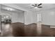 Open-concept living room showcasing hardwood floors, recessed lighting, and seamless flow into kitchen at 205 Spring St, Louisburg, NC 27549