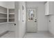 Bright mudroom with white cabinetry and a windowed door leading outside, perfect for organization at 205 Spring St, Louisburg, NC 27549