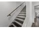 Elegant staircase with dark wood treads and a white painted riser and stringer at 205 Spring St, Louisburg, NC 27549