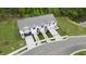 Aerial view of three townhouses with parking and landscaped yards at 22 Virgo Dr, Angier, NC 27501