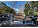 Spacious backyard featuring a deck, steps, and wooded boundaries at 223 N Main St, Wendell, NC 27591