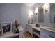 Elegant bathroom featuring dual vanities, marble countertops, and patterned wallpaper at 223 N Main St, Wendell, NC 27591