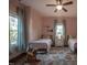 Bright bedroom with hardwood floors, large windows, and charming twin beds at 223 N Main St, Wendell, NC 27591