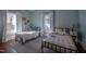 Bedroom with two beds, neutral paint, and lots of natural light at 223 N Main St, Wendell, NC 27591