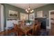 Spacious dining room featuring hardwood floors, brick fireplace and ample natural light at 223 N Main St, Wendell, NC 27591