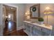 Inviting entryway with hardwood floors, decorative table, mirror and lamps at 223 N Main St, Wendell, NC 27591