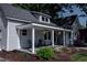 Charming home with a covered front porch, colorful flowers, and manicured landscaping at 223 N Main St, Wendell, NC 27591