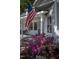 Inviting front porch with American flag, seating, and lush landscaping at 223 N Main St, Wendell, NC 27591
