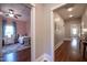 Hallway showing bedroom with ceiling fan, hardwood floors, and natural light at 223 N Main St, Wendell, NC 27591