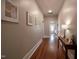 Long hallway featuring hardwood floors, recessed lighting, and tasteful decor at 223 N Main St, Wendell, NC 27591