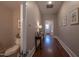 Inviting hallway featuring hardwood floors, neutral paint, and decoratively framed art at 223 N Main St, Wendell, NC 27591