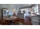 Open kitchen and dining area with white cabinets and stainless steel appliances at 223 N Main St, Wendell, NC 27591