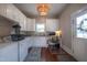 Combined laundry and office space with built-in desk, and bright white cabinets at 223 N Main St, Wendell, NC 27591