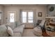 Bright living room features a large window, hardwood floors, and cozy seating at 223 N Main St, Wendell, NC 27591