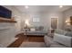 Cozy living room with fireplace, hardwood floors, and comfortable seating area at 223 N Main St, Wendell, NC 27591