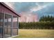 Picture of the backyard with a screen house, with a line of trees in the background at 241 Fair Oaks Ct, Mebane, NC 27302