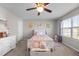 Bright bedroom featuring a large window, neutral paint, carpeted floors, and ceiling fan at 241 Fair Oaks Ct, Mebane, NC 27302