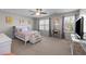 Bright bedroom featuring two large windows, neutral paint, and carpeted floors at 241 Fair Oaks Ct, Mebane, NC 27302
