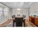Formal dining room with coffered ceiling, granite table, and hardwood floors at 241 Fair Oaks Ct, Mebane, NC 27302
