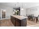 Modern eat-in kitchen featuring a large central island, stainless appliances and bright, recessed lighting at 241 Fair Oaks Ct, Mebane, NC 27302
