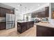 Kitchen with dark cabinets, granite counters, and large island at 241 Fair Oaks Ct, Mebane, NC 27302