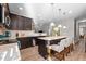 Spacious kitchen featuring an island, dark cabinetry, and granite countertops at 241 Fair Oaks Ct, Mebane, NC 27302