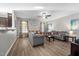 Living room with gray sofas, wood coffee table, and ceiling fan at 241 Fair Oaks Ct, Mebane, NC 27302
