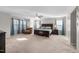 Spacious main bedroom with a ceiling fan, chair, and three large windows at 241 Fair Oaks Ct, Mebane, NC 27302