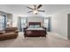 Spacious main bedroom with a ceiling fan, chair, and three large windows at 241 Fair Oaks Ct, Mebane, NC 27302