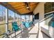 Relaxing screened porch with patio furniture and ceiling fan at 241 Fair Oaks Ct, Mebane, NC 27302