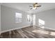 Sunny bedroom with wood-look floors and two windows at 341 Harts Creek Dr Dr, Pittsboro, NC 27312