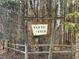 Harts Creek community entrance sign with wooden post and split rail fence at 341 Harts Creek Dr Dr, Pittsboro, NC 27312